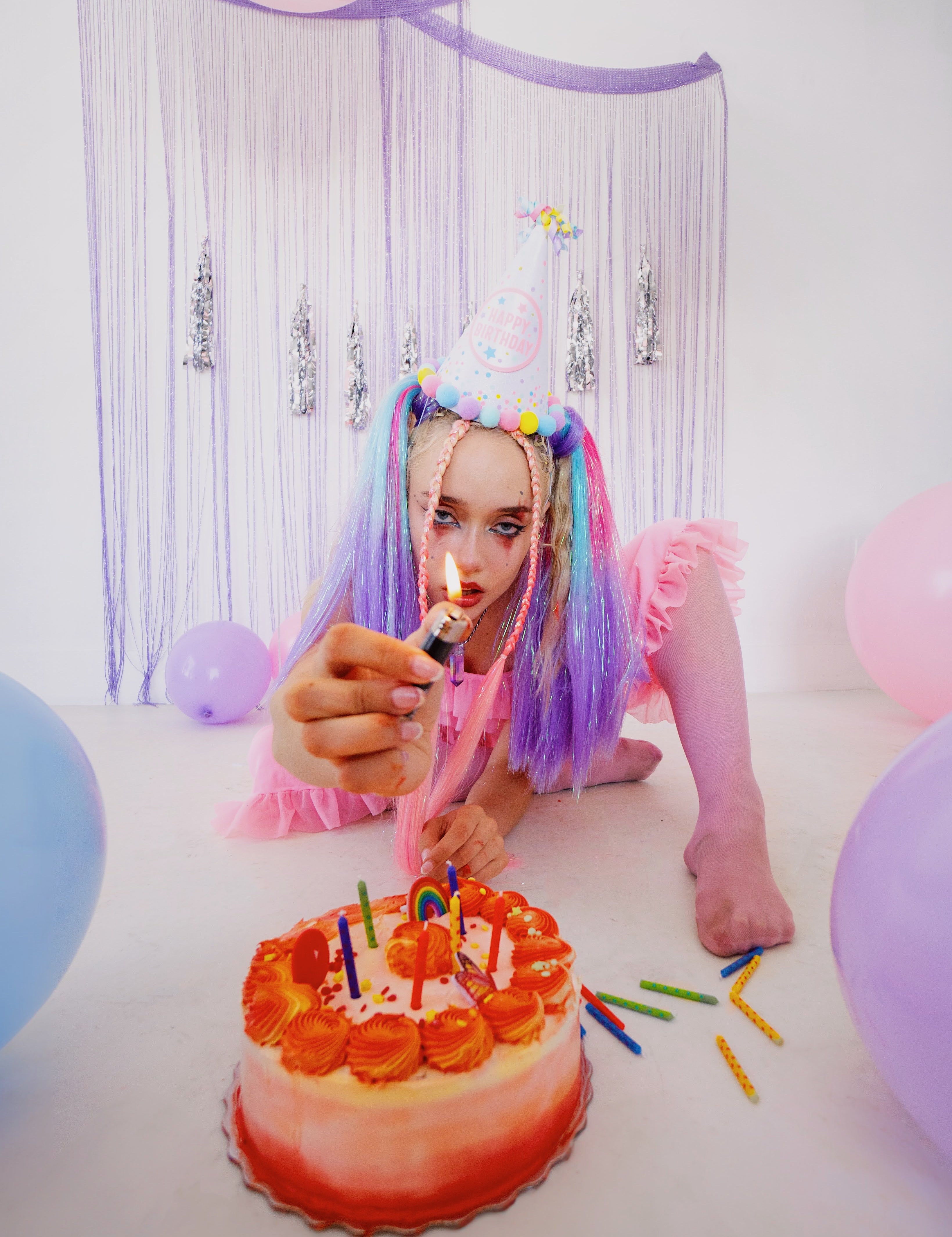 Woman holding lighter at Birthday party in rave attire