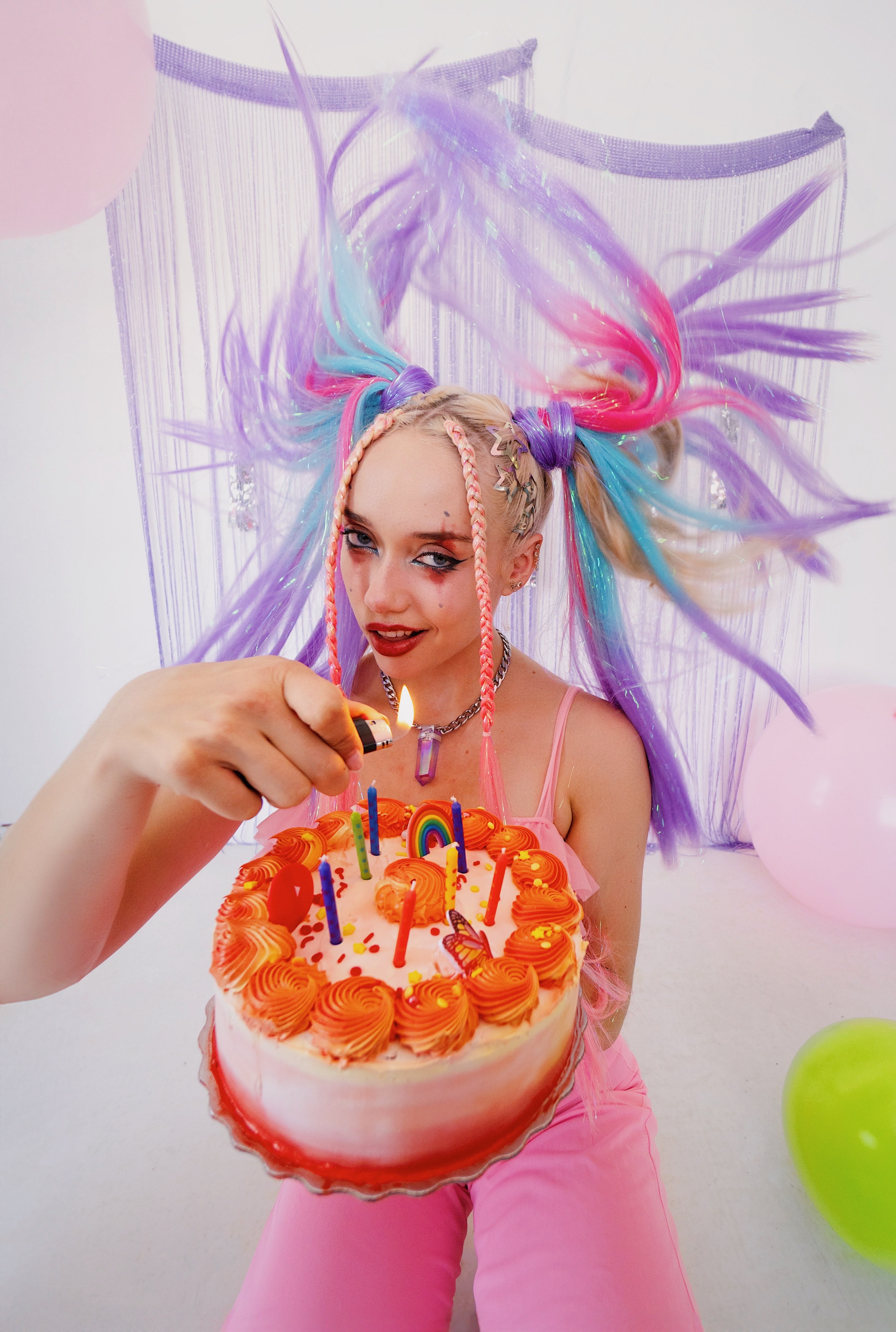 Woman lighting birthday candles for cake